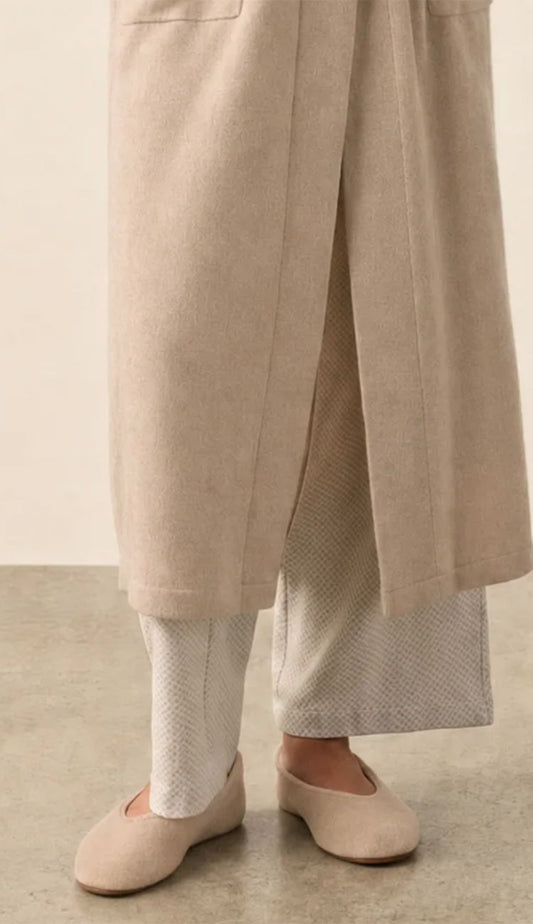 white and warren cashmere slippers in taupe heather on a model wearing pjs and a cashmere robe