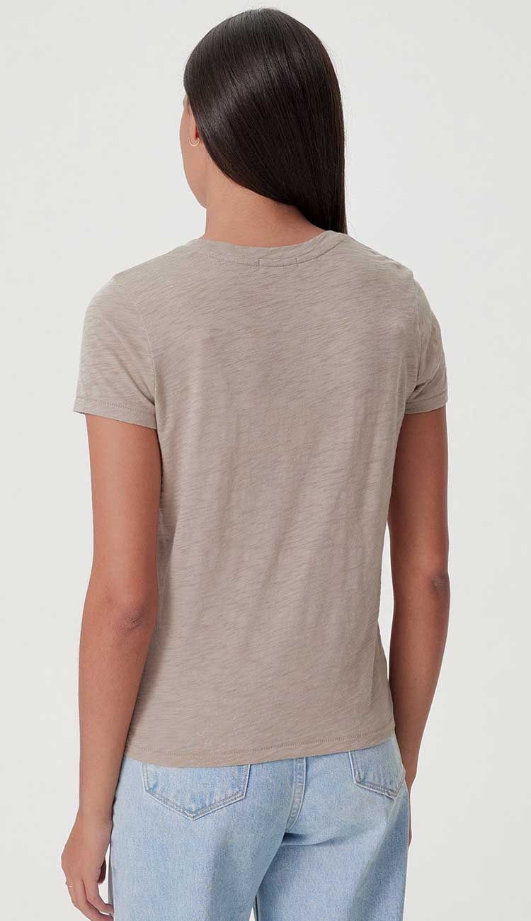 goldie boy tee in string beige color on a model on a white background back view of tee shirt
