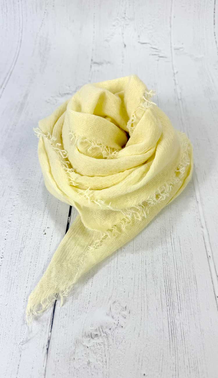 Yellow scarf on a white wooden surface