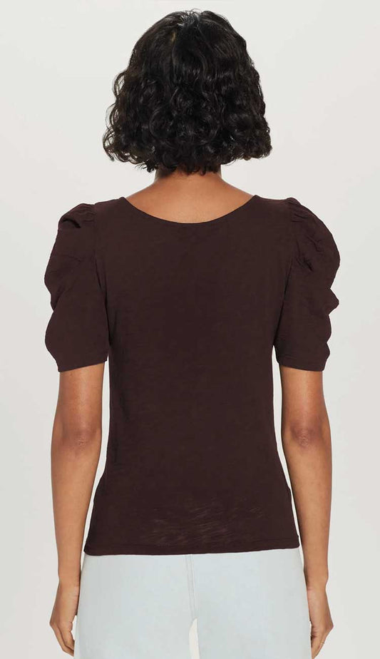 the dutchess t-shirt model wearing t-shirt with puffy sleeves back view in chocolate brown on a white back ground.