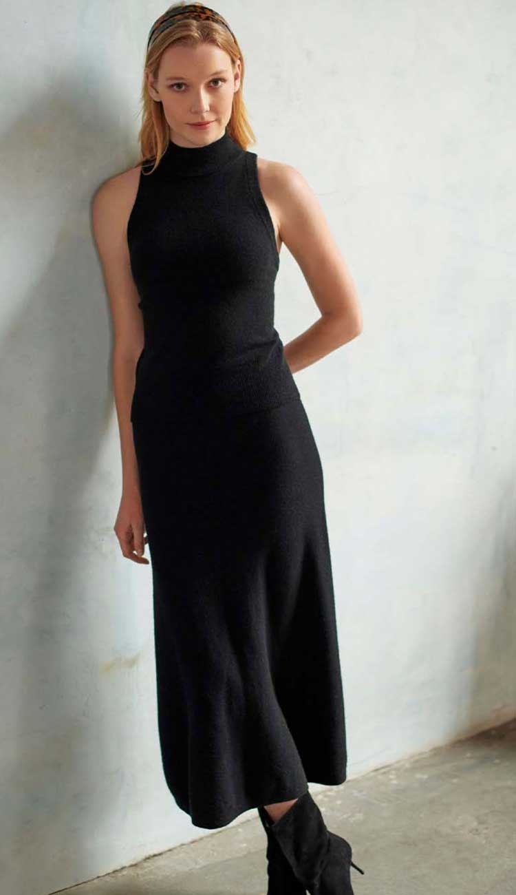 White + Warren Midi Cashmere Skirt in black cashmere with an a-line cut. Back view. shown with the sleeveless mockneck cashmere top