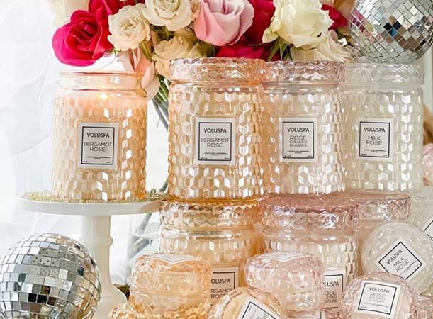 a collection of Voluspa Candles with roses 