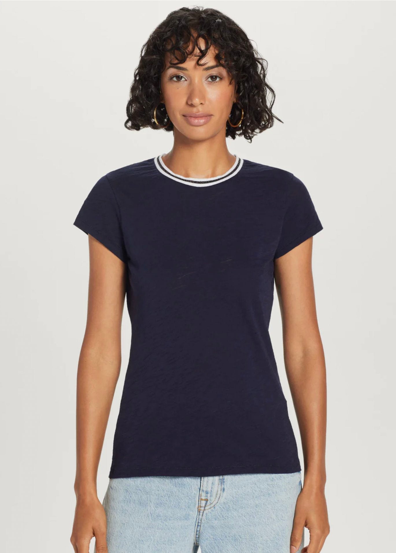Woman modeling a navy A GOLDE ringer T-shirt with white neckline trim for the women’s T-shirt collection