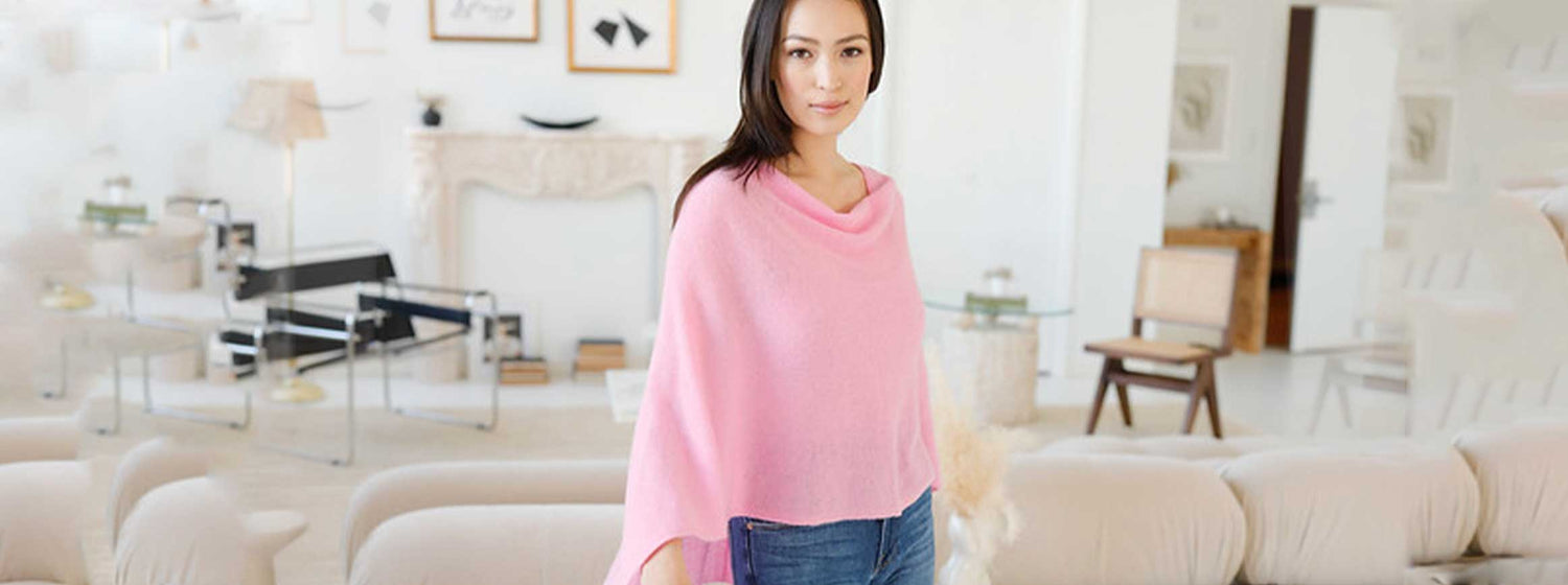 woman wearing a cashmere poncho in pink 
