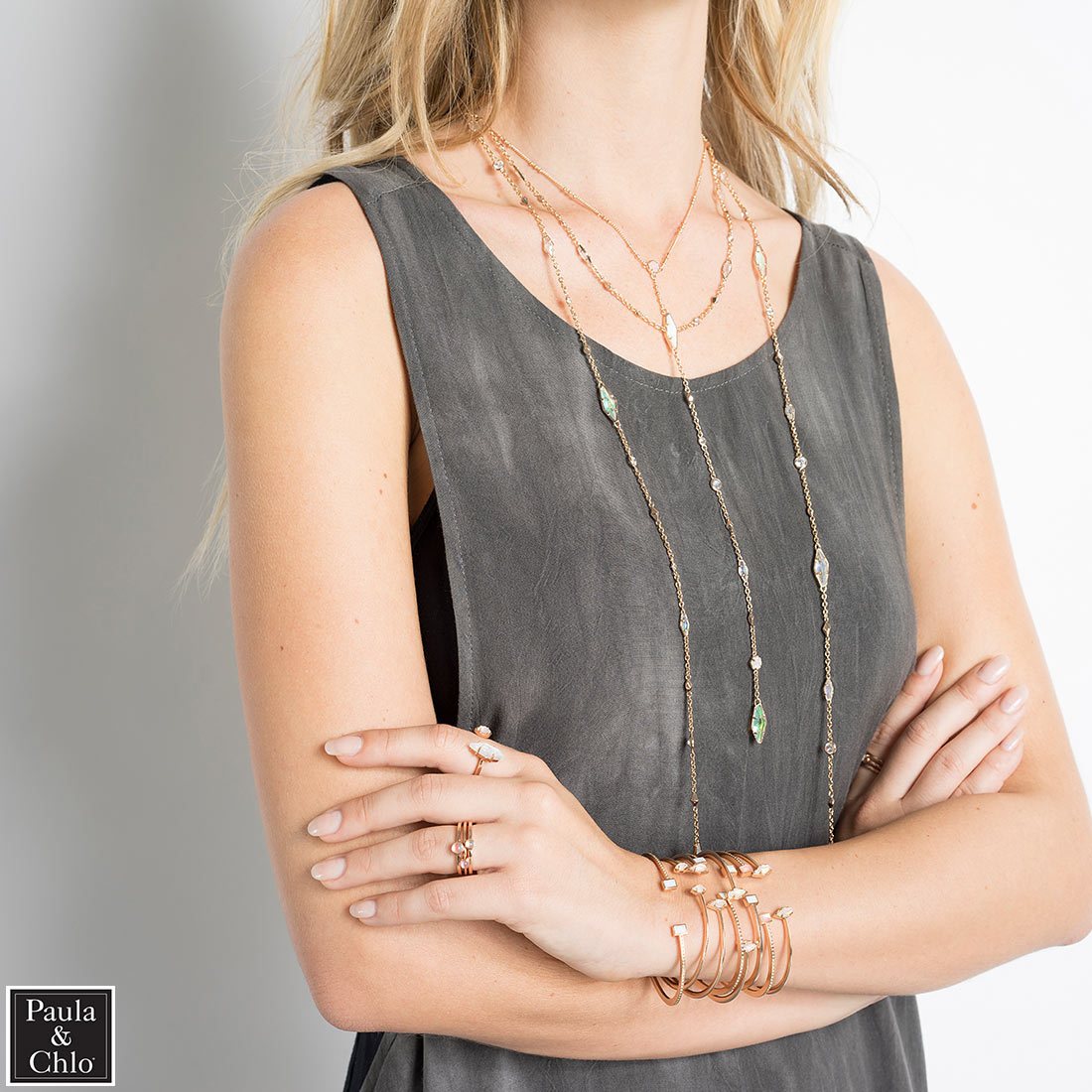 woman wearing bracelets, rings and neckalces