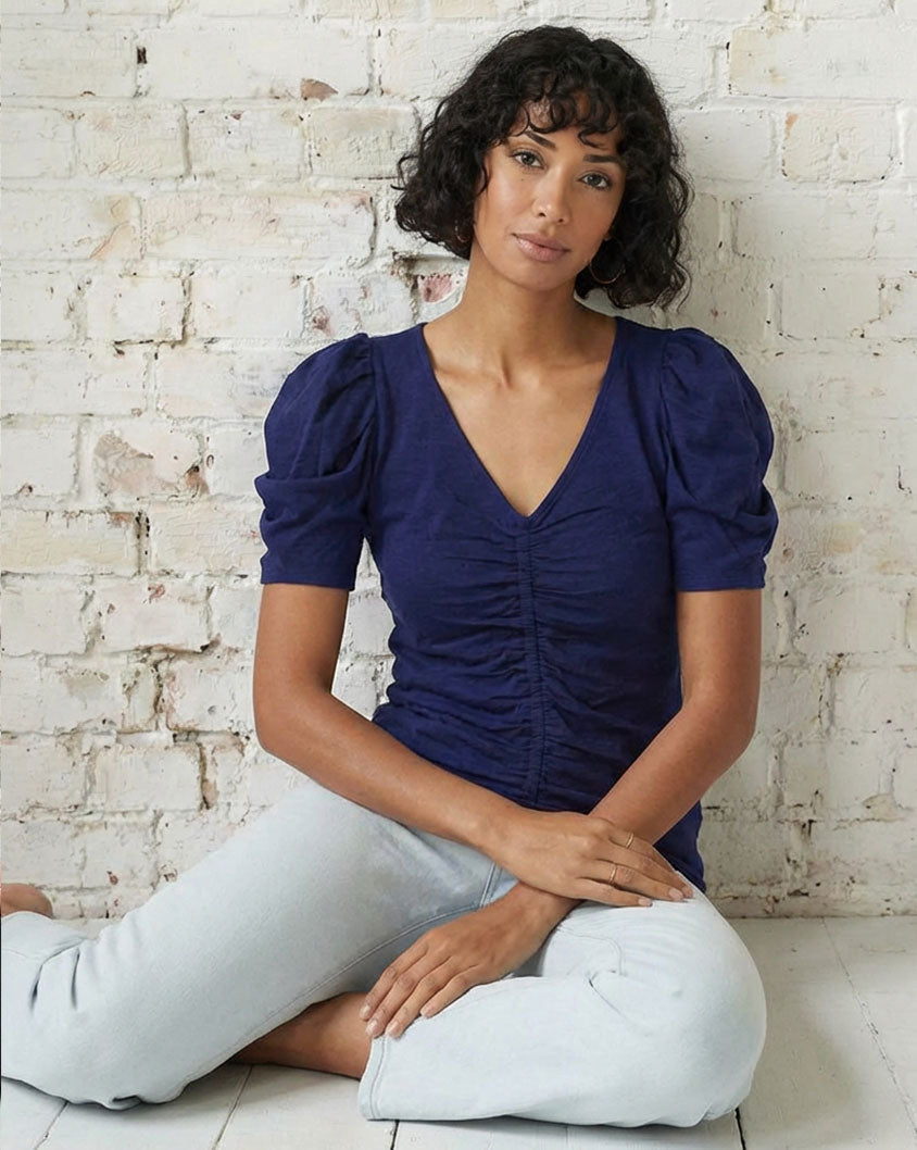 Model wearing the Goldie Duchess Tee in navy with puff sleeves, luxury women’s tee.
