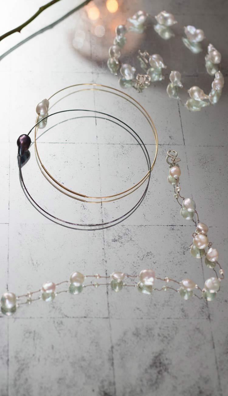 margot morrison pearl jewelry on a mirrored table