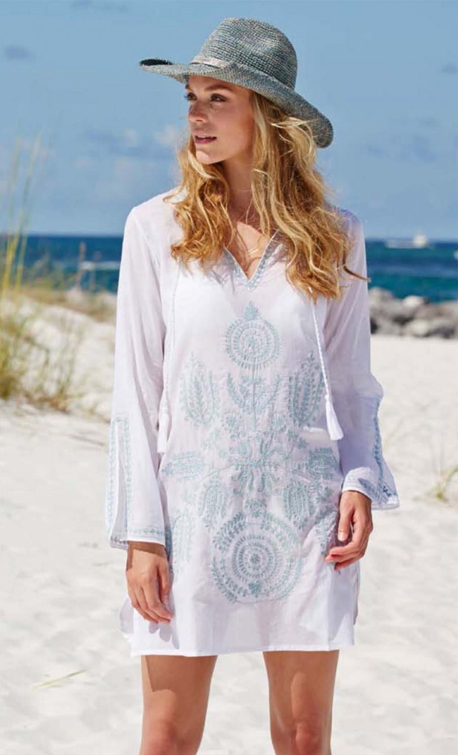 woman wearing a white kaftan and blue hat