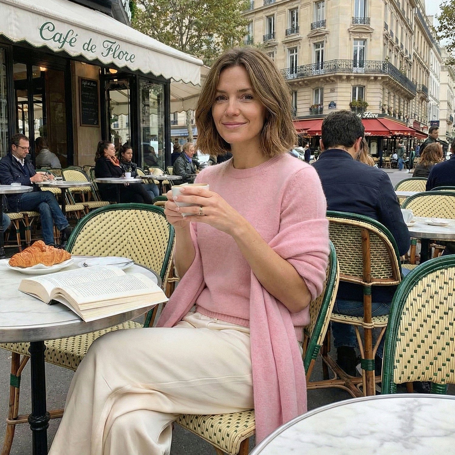 Woman wearing pink White + Warren cashmere travel wrap, a best-selling luxury everyday essential.