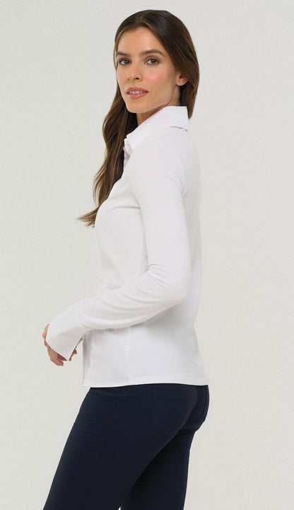 Woman wearing the Alida Anatomie Shirt in white with a navy pant - side view with a whtie background