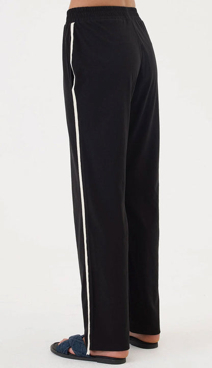 Goldie Everyday Black pants with white stripes on a white background - back view