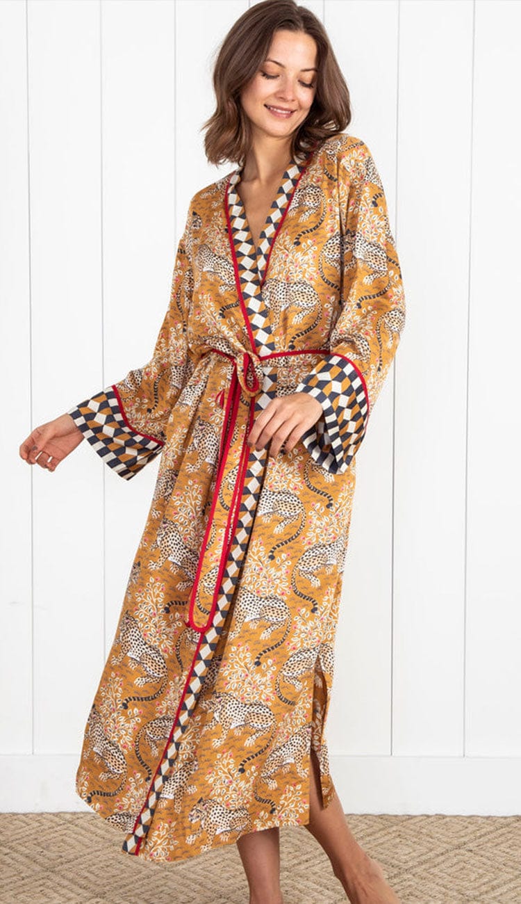 Woman wearing a Printfresh lightweight viscose robe in a tobacco leopard print, shown on a light background.
