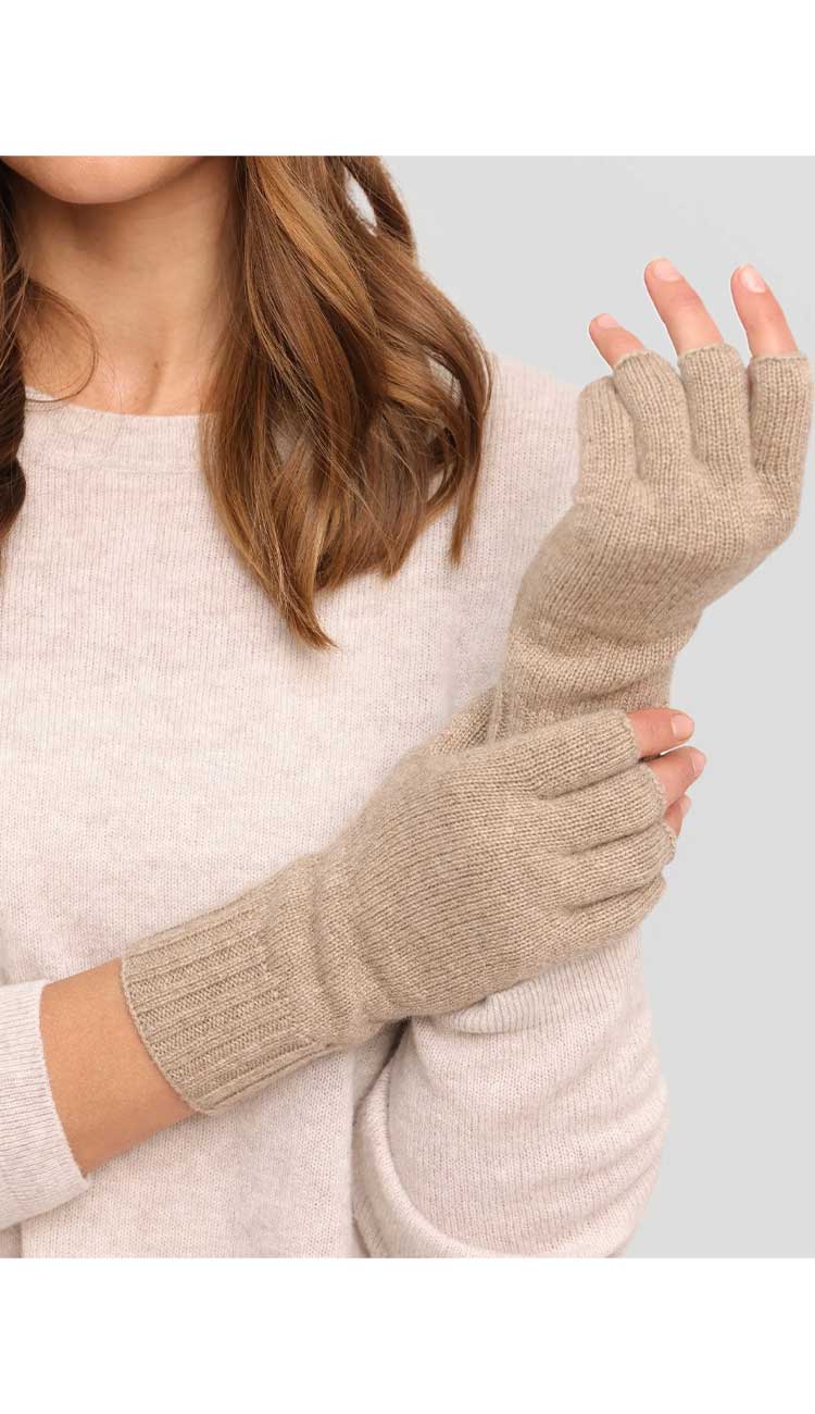 Beige fingerless gloves worn by a person against a neutral background