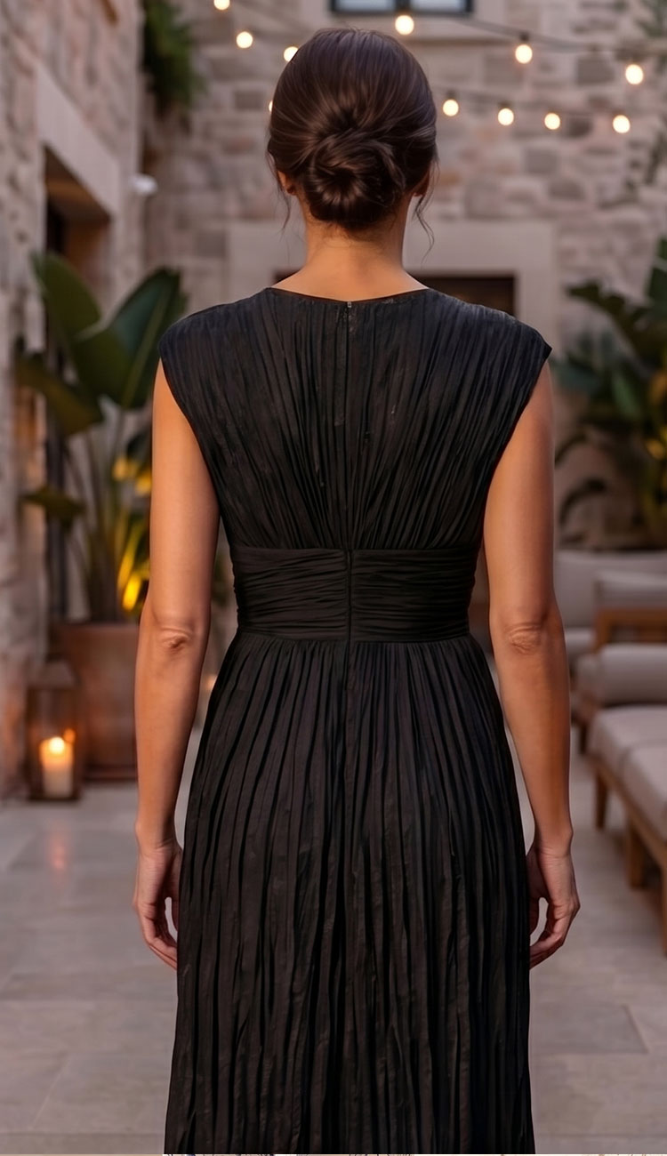 Woman wearing a black go silk crinkle dress back view 