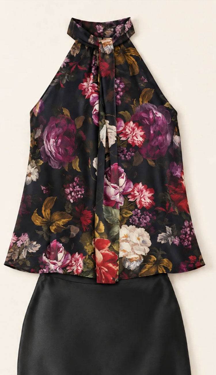 the go silk halter top in black with a floral print and a black go silk skirt