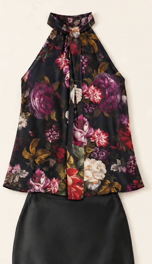 the go silk halter top in black with a floral print and a black go silk skirt