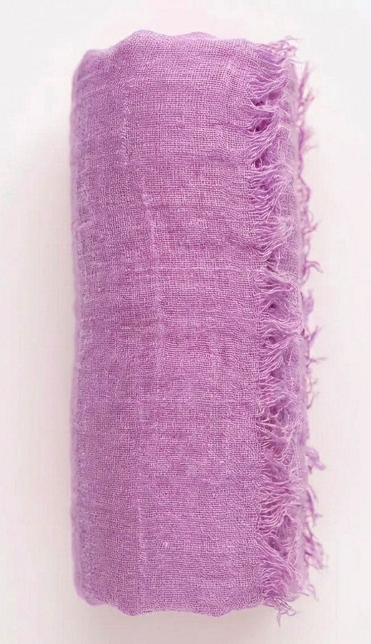 lavender textured fabric with frayed edges on a white background