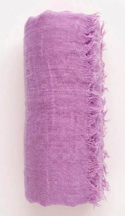 lavender textured fabric with frayed edges on a white background