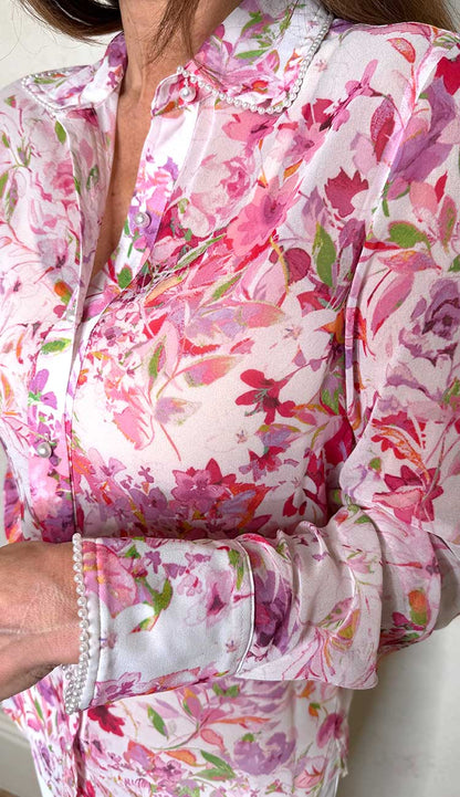 detail view of floral shirt with pearl detail on sleeves