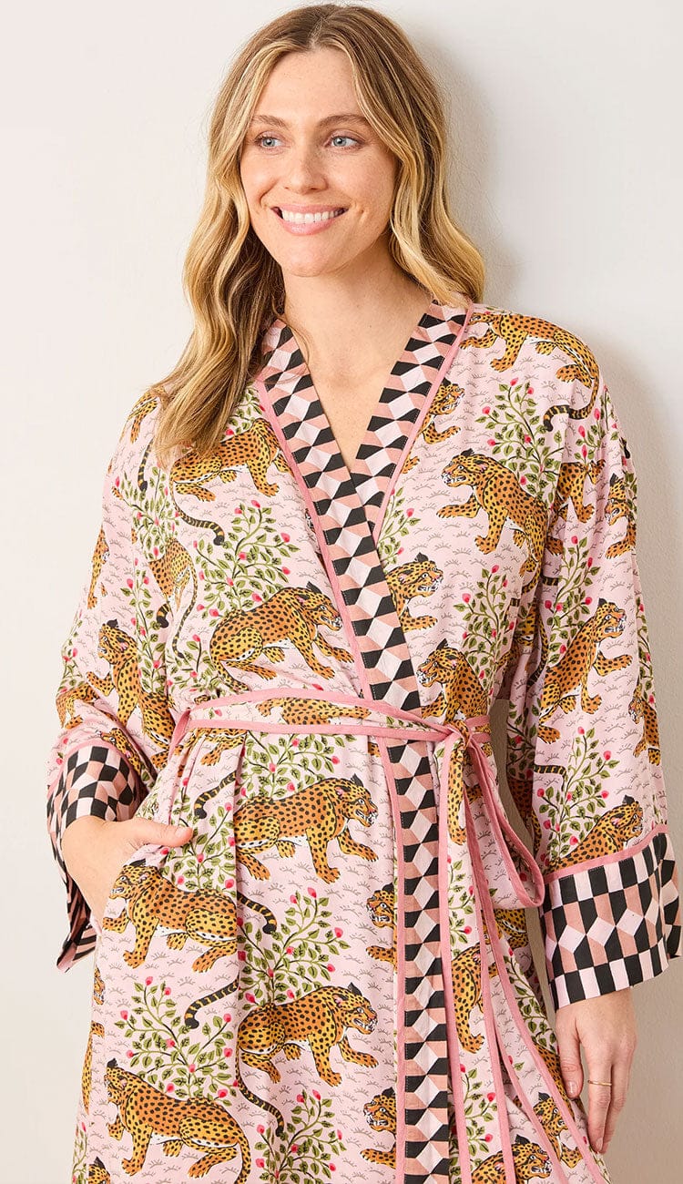 Detailed image of a Woman wearing a Printfresh lightweight viscose robe in a blush pink leopard print, shown on a light background.