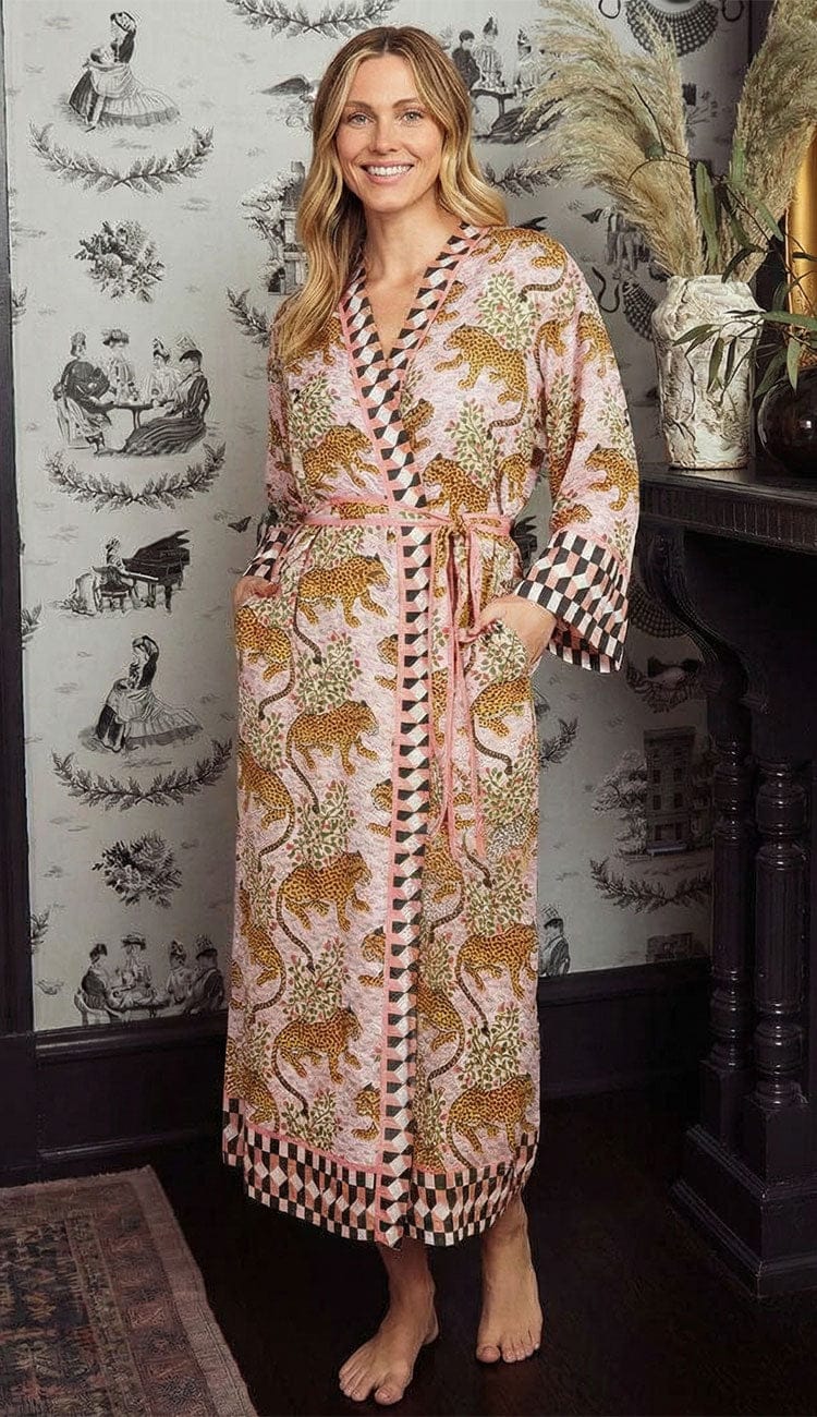 Woman wearing blush Printfresh Eco Satin Robe in Bagheera leopard print with tie waist and patterned trim