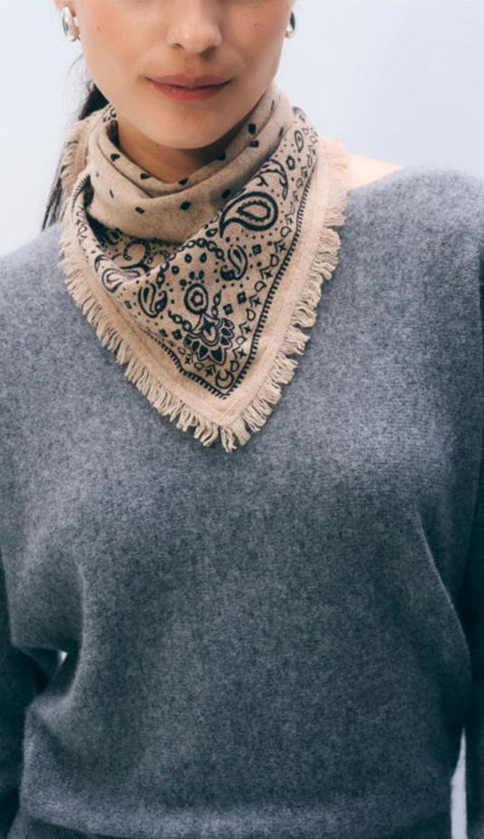 Woman wearing a White and Warren taupe heather bandana with a heather grey sweater on a white background.