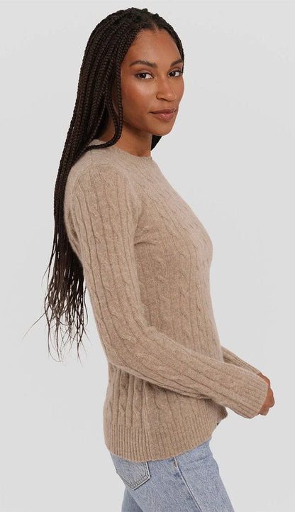Side profile of a women's cable knit cashmere pullover by Alashan Cashmere. The image highlights the 24.5-inch body length, the texture of the 2-ply yarn on the sleeves, and the relaxed yet tailored fit of the garment from the shoulder to the hem. In Chai,