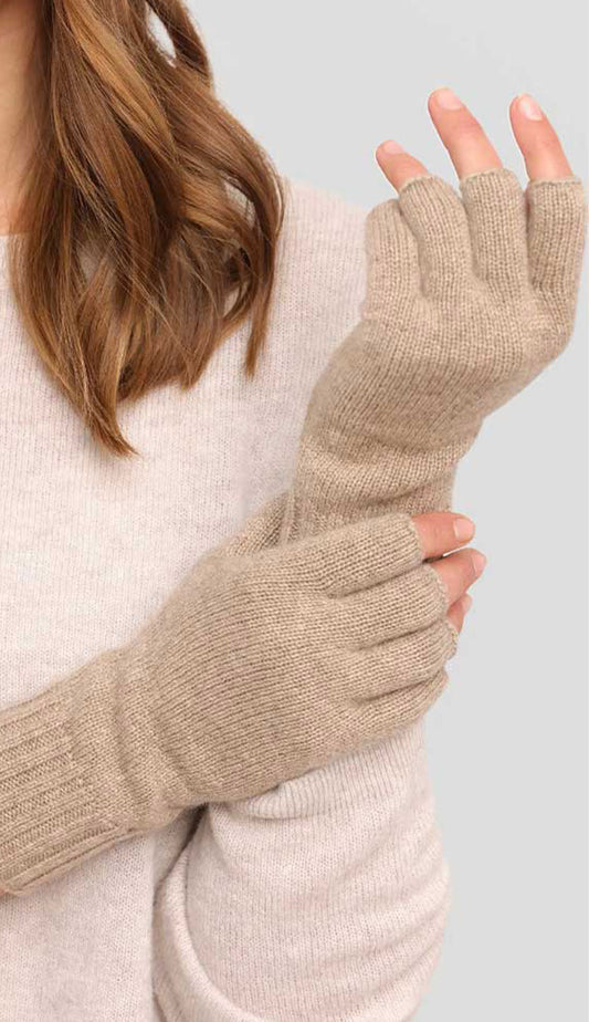Alashan Cashmere fingerless gloves  in natureal worn by a person against a light background