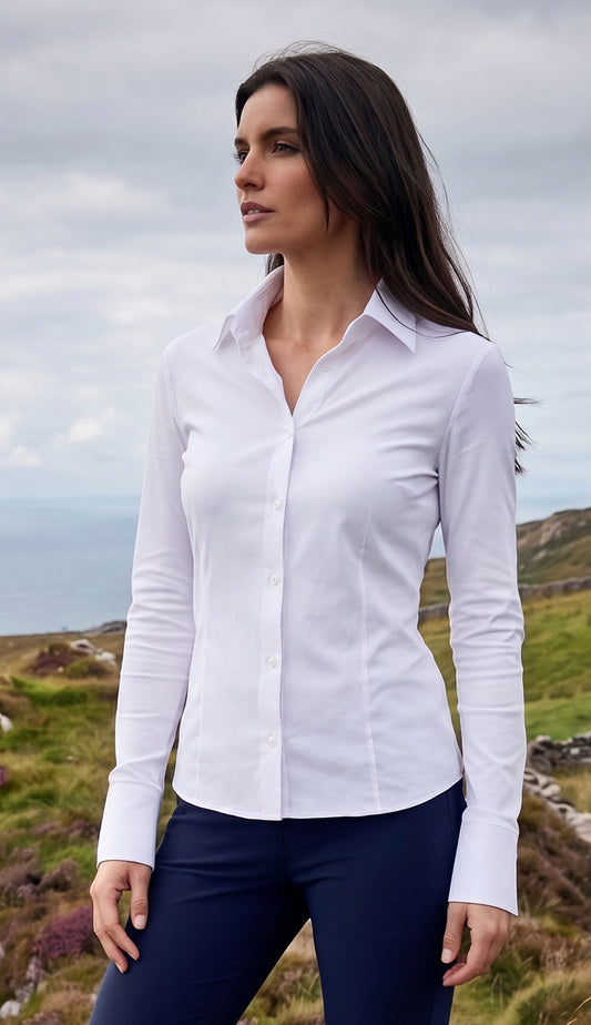 Woman wearing the Alida Anatomie Shirt in white with a navy pant.