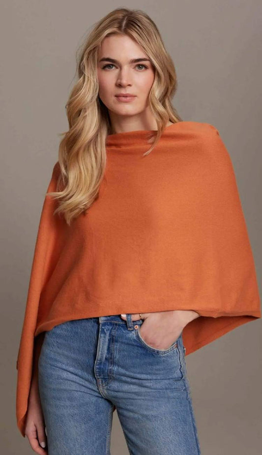 Woman wearing the Alashan Cotton Cashmere Trade Wind Dress Topper in Carrot Cake, styled with blue jeans, featuring a relaxed draped silhouette and soft cotton cashmere knit.