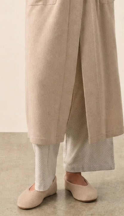 white and warren cashmere slippers in taupe heather on a model wearing pjs and a cashmere robe