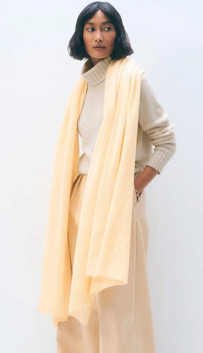 White + Warren cashmere travel wrap in Cornsilk, a lightweight rectangular 100% cashmere wrap styled as a scarf.