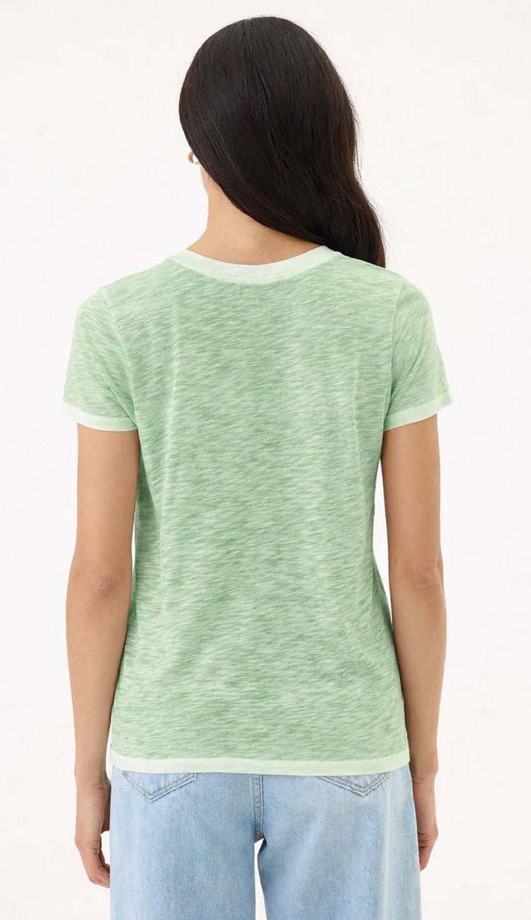 Goldie Tee in Sunwash palm green on a woman wearing blue jeans with a white background - backround