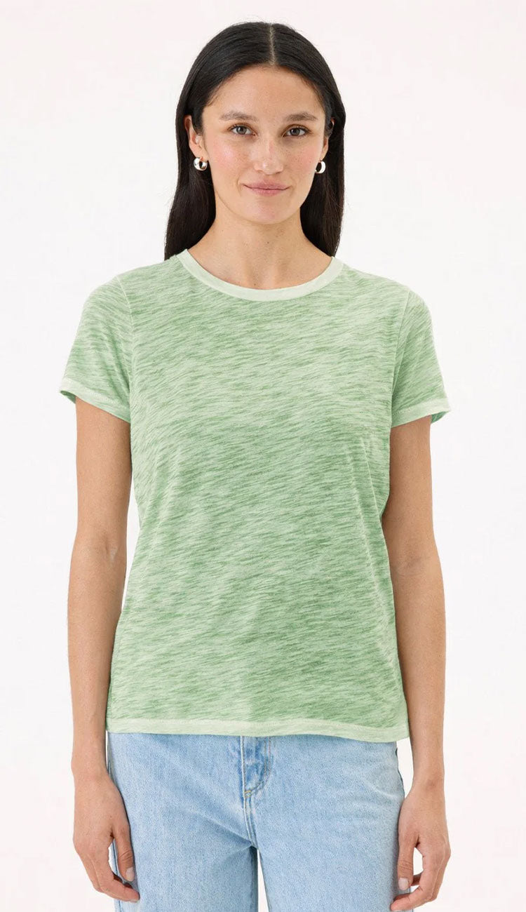 Goldie Tee in Sunwash palm green on a woman wearing blue jeans with a white background.