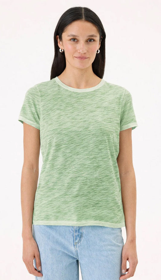 Goldie Tee in Sunwash palm green on a woman wearing blue jeans with a white background.