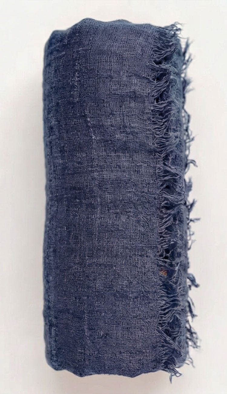 deep space Blue textured fabric with frayed edges on a white background