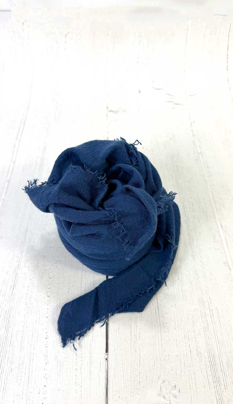 Blue scarf on a white wooden surface