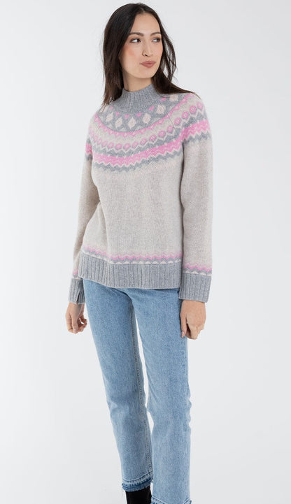 alashan cashmere faireisle sweater in shades of grey and pink with blue jeans
