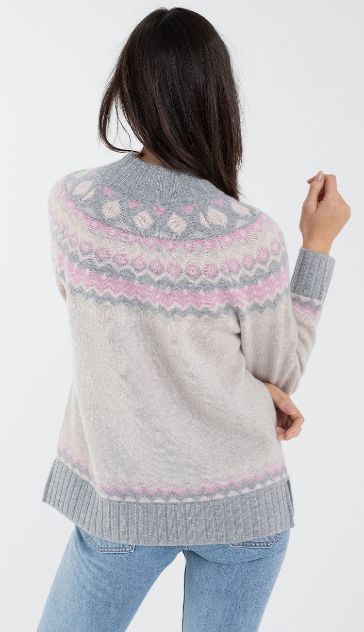 alashan cashmere faireisle sweater in shades of grey and pink with blue jeans back view