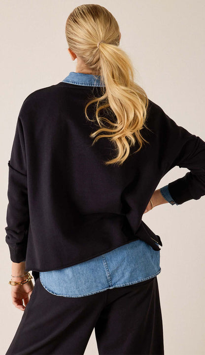 back view a woman wearing the frenchie side zip crewneck with a blue jean shirt underneath