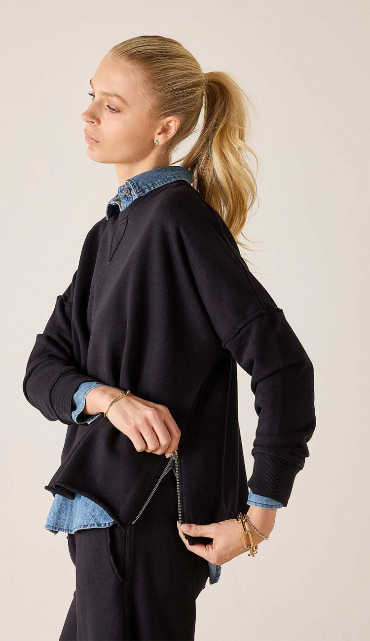 Woman wearing the frenchie zip crewneck with a blue jean shirt under it 