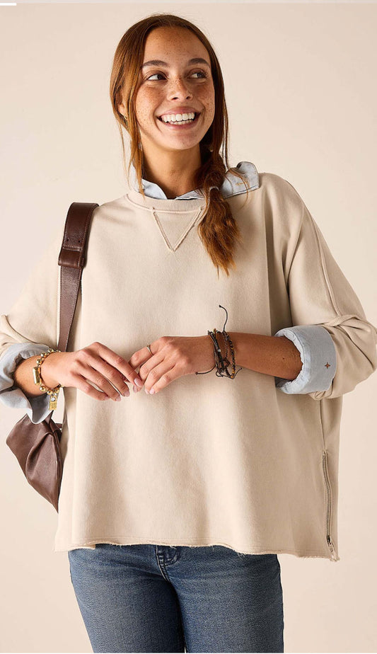 woman wearing the Mersea Frenchie Zip Side Crewneck in Bone, wearing jeans and a shirt underneath