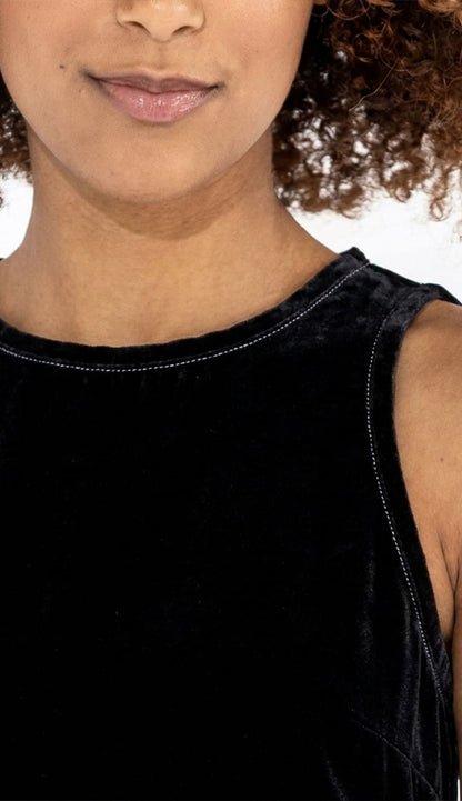 Person wearing the black go silk decompress sleeveless top detail view with a blurred background