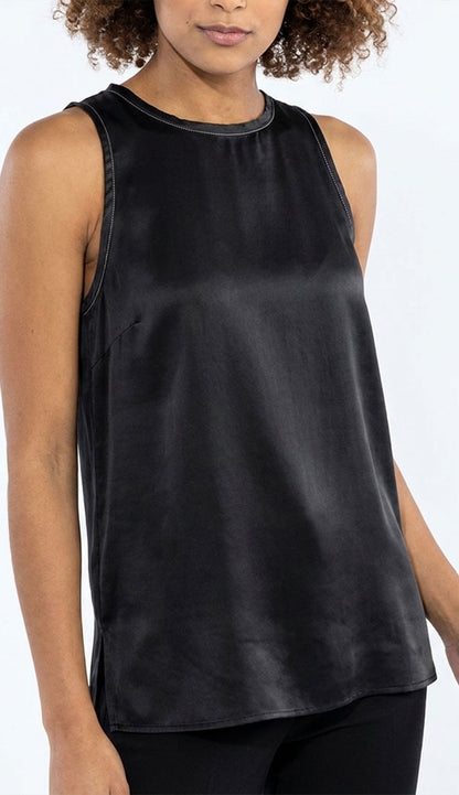 Woman wearing the go silk decompress black sleeveless top on a white background
