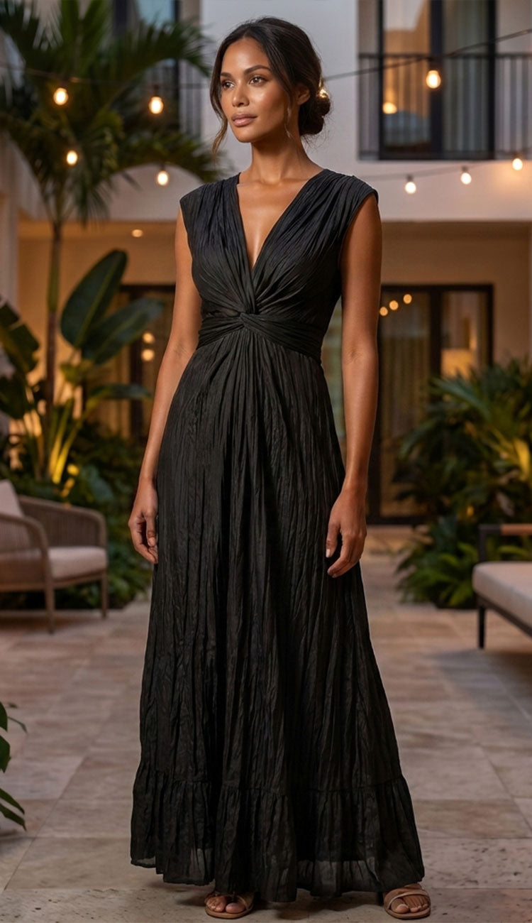 go crinkle cut wist dress in black on a woman on a backyard patio.