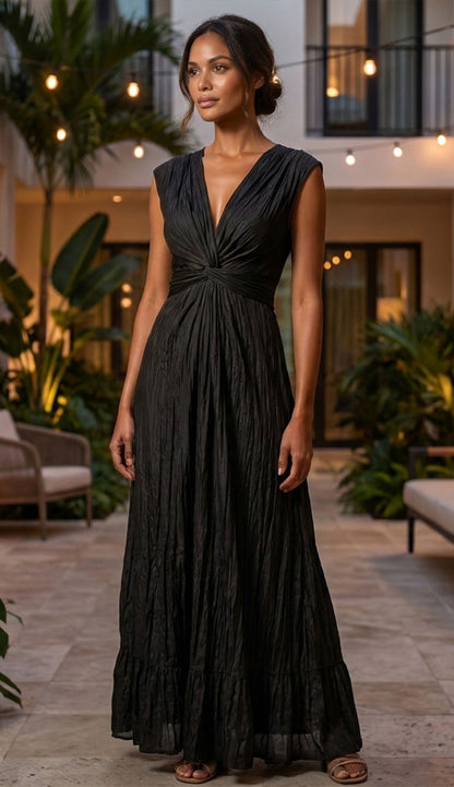 go crinkle cut wist dress in black on a woman on a backyard patio.