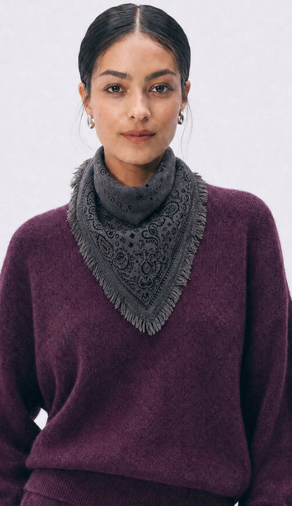 Woman wearing a White and Warren heather grey bandana with a plum sweater on a white background.