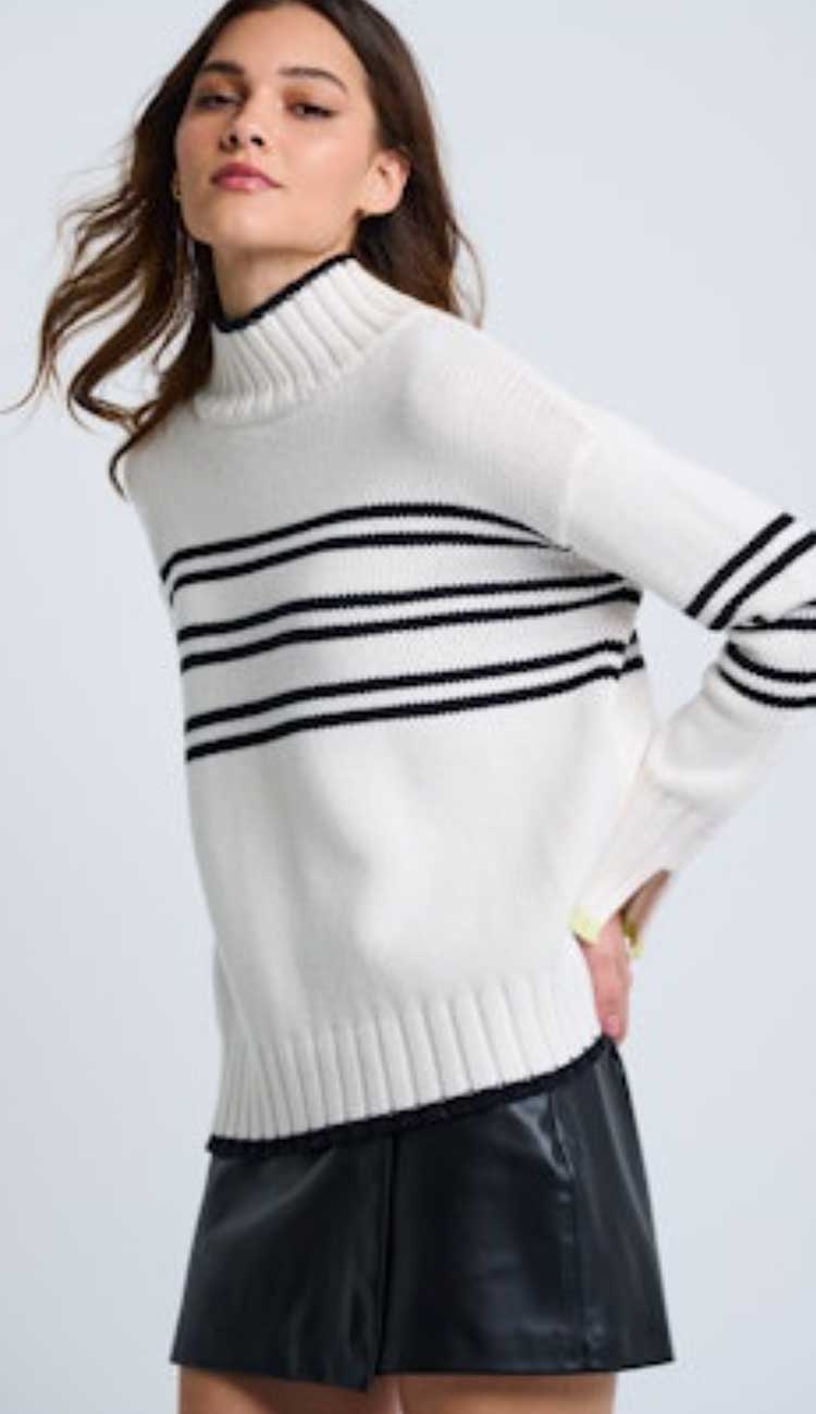 highline sweater with a mockneck in white with 3 sets of 2 horizontal stripes on the bodice and sleeve on a female with a light grey background.