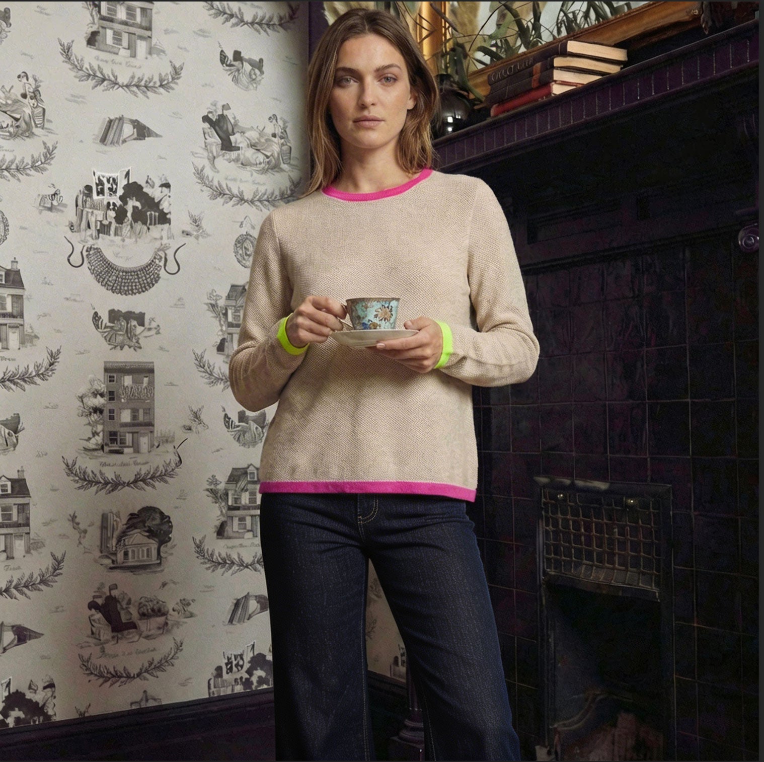 Model wearing a creamLisa Todd sweater with colorful trim, styled as luxury women’s knitwear.