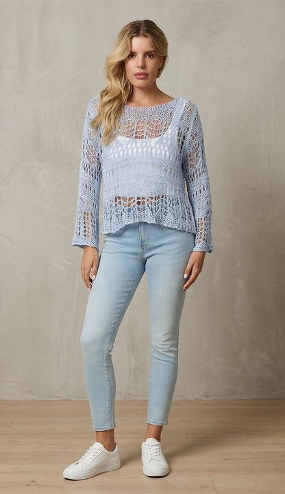 Woman wearing milio milano sky blue crochet top with jeans against a neutral background